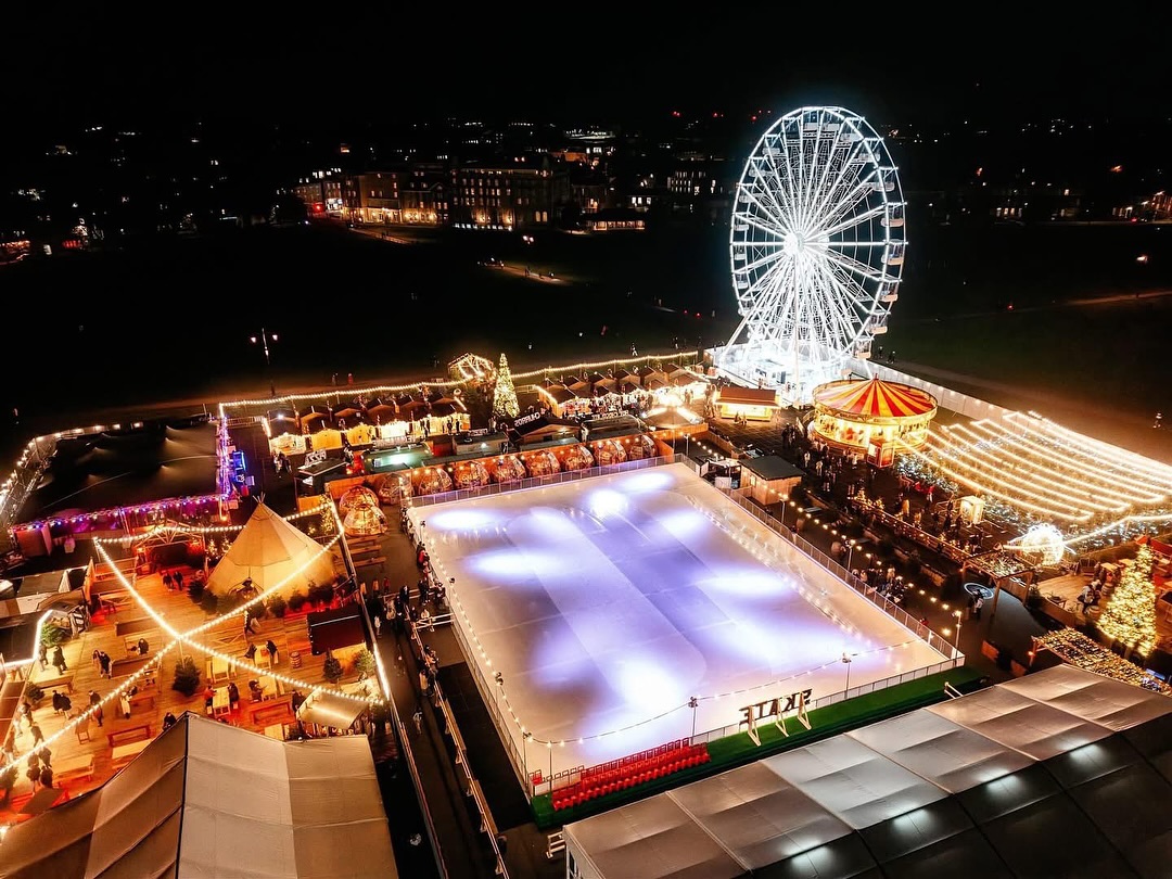 An aerial photo of Cambridge ice rink 2024. The ice rink is empty and surrounded by bright lights.