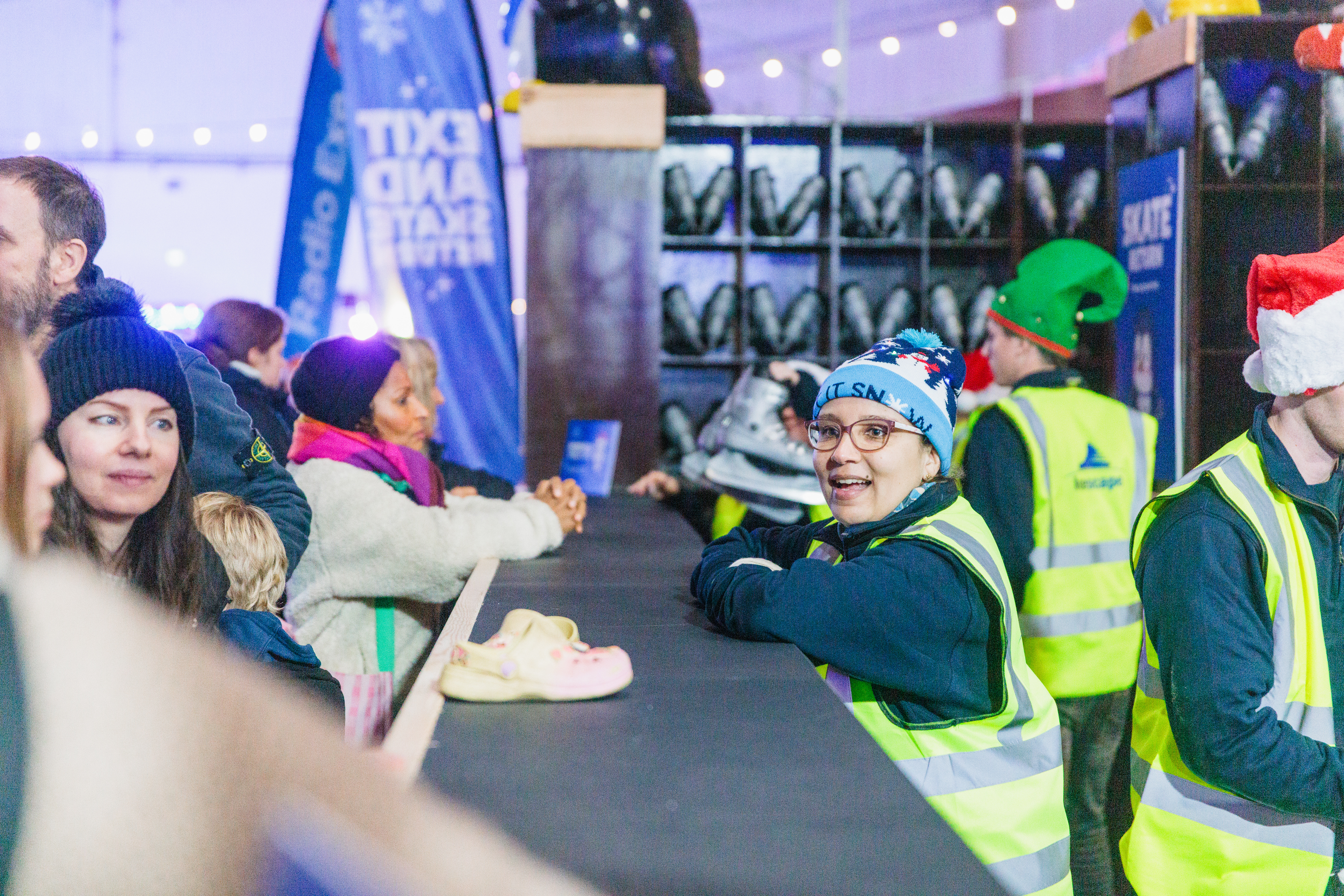 Icescape ice rink staff serving customers their skates at w inter ice rink. 