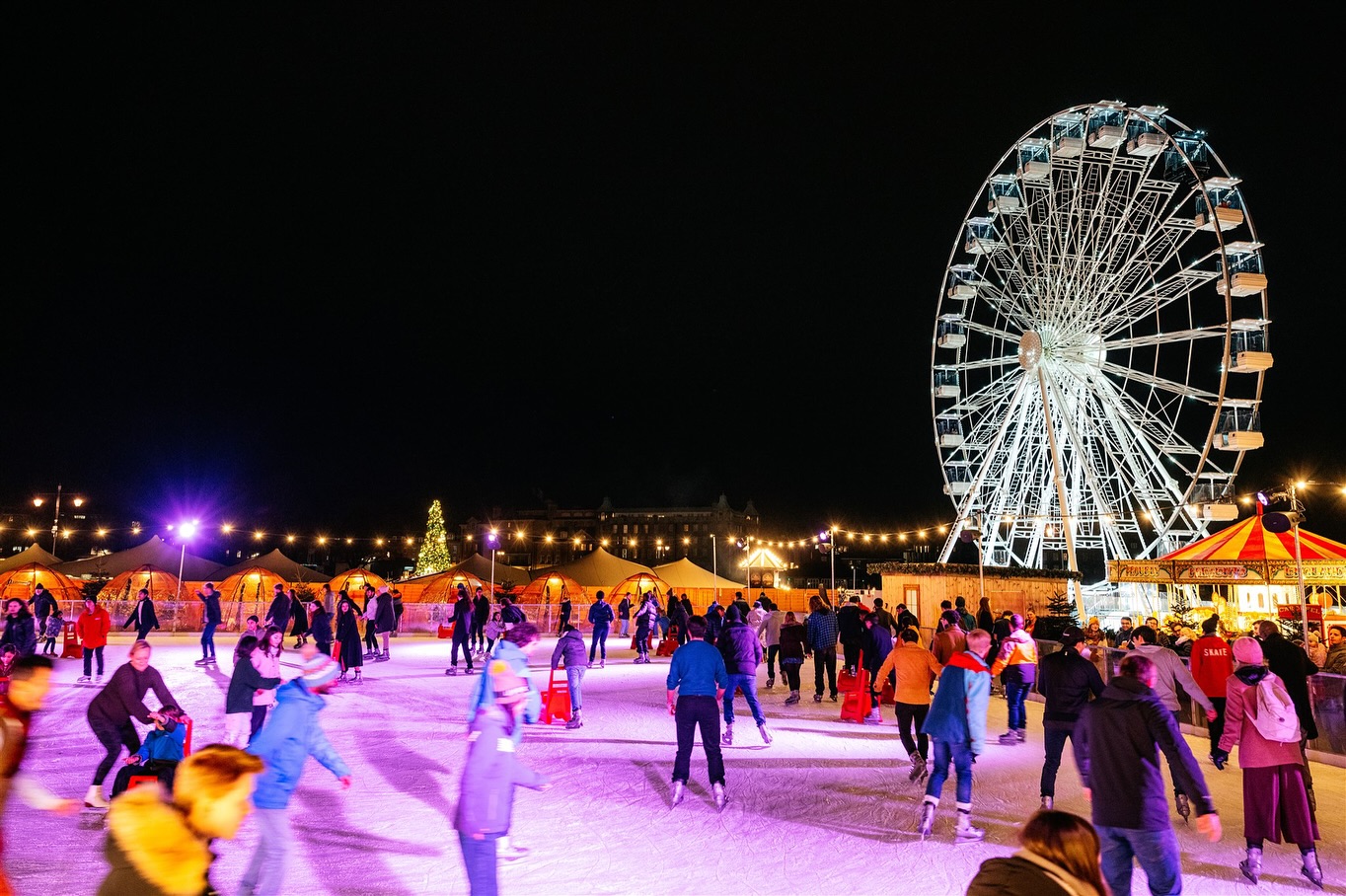 Ice skaters enjoying the festive winter ice rink in Cambridge. 